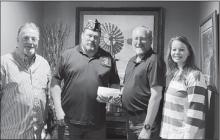 Slayton American Legion Post 64 Commander Brad Pagel accepting $1000 donation from Farmers Agency of Avoca toward the Vietnam Wall and Cost of Freedom displays coming to Slayton during the Murray County Fair Aug 15-20 2023. Left to right Tom Ackerman, Brad Pagel, Mike Frank Missy Biren