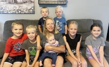 Retiring Childcare Provider Gail Johnson sits with her current kiddos, Cayden Homan, Colin Reith, Daisy VanDyke, Porter VanDyke, Johnson, Aiden Ebbers, Charli VanDyke, Kennedy Homan
