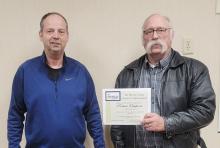 Murray County Commissioner Mark Carlson presents certificate to Robert Ossefoort