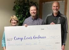 Receiving a check for $390 for CLE are l to r, Janet Voges CLE Treasurer, Jeremey Adler – CLE Board member, Marv Nysetvold – SLM Executive Director