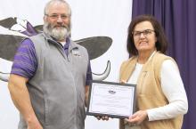 Tony Clarke presents Sue Streff with her plaque for 16 years of service to the MCC School District.