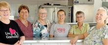 Jan Cuperus, Nancy Fell, Judy Schoberg, Jenny Herding, Pam Steen and Dianna Williams help serve a meal to rummage sale patrons through the Friends of Hospice group.