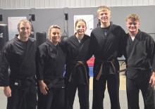 Pictured above, L to R, are: Warrior Training Academy Instructor Ryan Koopman, Owner/Instructor Jen Tiesler, promoted Black Belt Brynlee Farris, promoted black belt Cullen VanderBeek and Instructor Jaxson Tiesler.