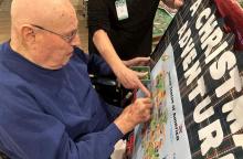 Harold Fischer checks on the progress of the Christmas Adventure ornament map.