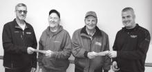 Pictured is Curt Van Dyke, Board Chairman (left), presenting a retirement check to Harley Buys, and Jeff Einck, Manager (right) presenting a check to Verlin Rylaarsdam.