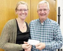 Maike Houser of Houser Homes, presents a check to Myron Koets, president of the Friends of the Casey Jones Trail.