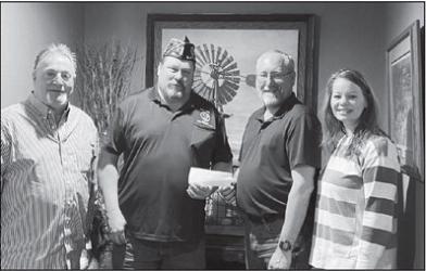 Slayton American Legion Post 64 Commander Brad Pagel accepting $1000 donation from Farmers Agency of Avoca toward the Vietnam Wall and Cost of Freedom displays coming to Slayton during the Murray County Fair Aug 15-20 2023. Left to right Tom Ackerman, Brad Pagel, Mike Frank Missy Biren