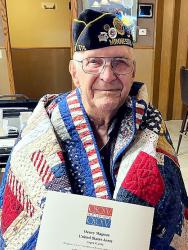 Henry “Hinie” Magnus with his Quilt of Valor