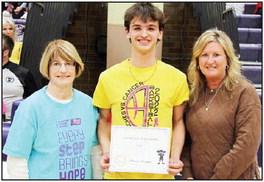 Tanner Graphenteen presented $257 collected from t-shirt sales.
