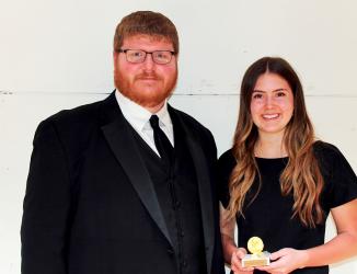 Director Michael Helgeson presenting Symone Harms with the John Philip Sousa Award. Mary Lou McNab was unable to attend, but received the Patrick S. Gilmore Award.