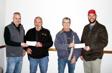 Pictured: Jeff Einck, CEO Manager (left) is shown presenting a retirement check to Lee Vande Griend and Josh Bonnstetter, Board Chairman (right) presents a check to Glen Schoolmeester.
