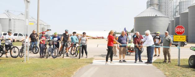 Members of the Friends of the Casey Jones Trail, along with State Representative Joe Schomacker, Pipestone Commissioner Dallas Roskamp, and DNR representative Chris Ingrebretson, celebrated the ribbon-cutting ceremony marking the completion of the final two miles of paving. This achievement officially extends the trail from Woodstock to Pipestone.