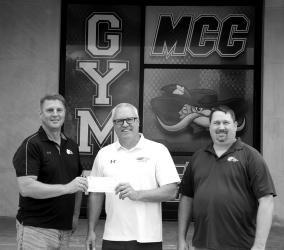 Brian Gass with First National Bank presented a check of $5,000 to MCC Superintendent Joe Meyer for the gymnasium floor project. Meyer was happy to report this puts them over the 1/2 way mark for fundraising for the project and thanks everyone for their generosity. Also pictured is Gary Haken with First National Bank.
