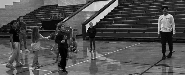 Mauricio Garcia watches as Fulda Elementary School students take turns shooting during Hoops for Heart.