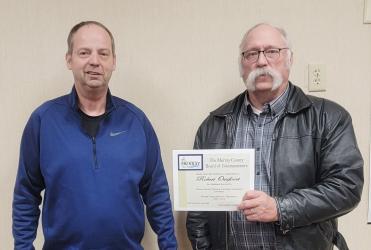 Murray County Commissioner Mark Carlson presents certificate to Robert Ossefoort