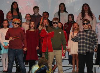 Giovanni Birt, Atz Mitchell, and Quinn Oakland, members of the Fulda Elementary School 5th and 6th grade choir, brought laughter from the audience with their performance of “We Will Jingle”.