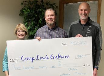 Receiving a check for $390 for CLE are l to r, Janet Voges CLE Treasurer, Jeremey Adler – CLE Board member, Marv Nysetvold – SLM Executive Director