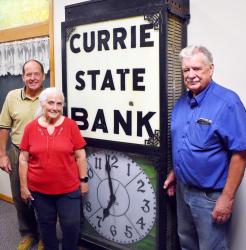 Doug Hansen, Mary Molitor and Don Hansen with the clock at its new home End-O-Line Park.