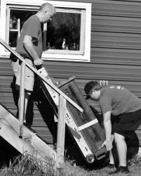 Above Right - Quist Moving &amp; Storage loading the large clock onto the bucket to get out of barn loft. Above - Smaller clock coming down. Below Left Top - Loading into moving truck. Below Left Bottom Unloading clock into End-O-Line Park.
