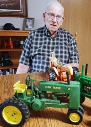 This is Don with the first two John Deere tractors he built.