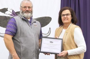 Tony Clarke presents Sue Streff with her plaque for 16 years of service to the MCC School District.