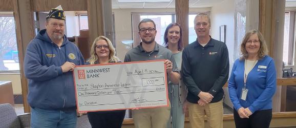 Slayton Legion Commander Brad Pagel accepts a $1,000 check from Minnwest Bank for the Remebering the Fallen tribute. Left to right, Pagel, Bobbi Atwood, Josh Onken, Katie Ahrendt, Neal Everson and Penny Boock.