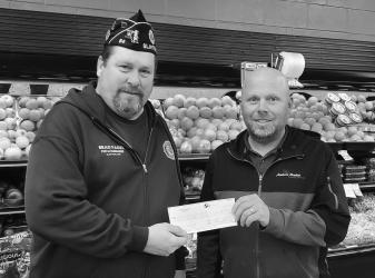 Slayton American Legion Post 64 Commander Brad Pagel accepting $750 donation from Almich’s Market (Travis Almich) towards the Vietnam Wall and Cost of Freedom displays coming to Slayton during the Murray County Fair Aug 15-20 2023.
