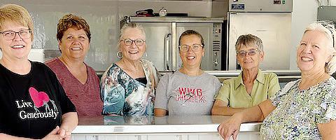 Jan Cuperus, Nancy Fell, Judy Schoberg, Jenny Herding, Pam Steen and Dianna Williams help serve a meal to rummage sale patrons through the Friends of Hospice group.