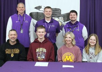 Andrew Holm signed his Letter of Intent to play football at the University of Minnesota-Morris on Wed., April 9. Andrew is pictured here with his Family: Jason,