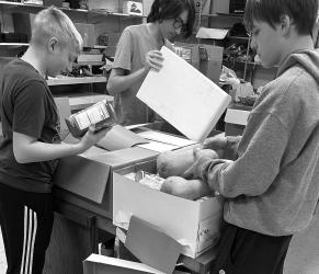 Fulda FCCLA students, Curtis Johnson, Jesse Swanson, and Aidyn Shaddix comprised the Christmas Boxes Food Drive project committee during the 2025 holiday season. They are shown above as they filled boxes for distribution to families in need.