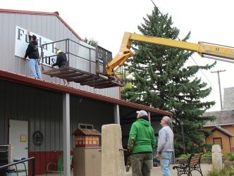 New signs were installed on the Fulda Heritage Museum on Thursday, October 1st by Western Print Group. Above, the sign is placed on the east end of the building by Cole Hennen and Eric Cox while Ted Winter and Randy Dierks watch the process.