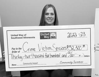 Carrie Buddy, Executive Director of New Horizons Crisis Center, receiving a community impact grant from the United Way of Southwest Minnesota.