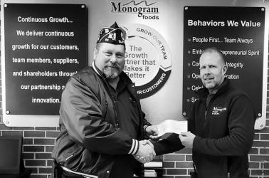 American Legion Post 64 Commander Brad Pagel accepting $1000 donation from Corey Kruse, Plant Engineering Manager, Monogram Foods Chandler MN, towards the Vietnam Traveling Wall display coming to Slayton MN Aug 15-20 2023.