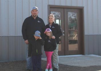 Tyson, Jordyn, Lachlan and Emerson Meyeraan are pictured at the entry door of their new Elite Auctions, LLC building just east of Fulda. An Open House is scheduled for Saturday, April 25, 4 to 7 p.m.