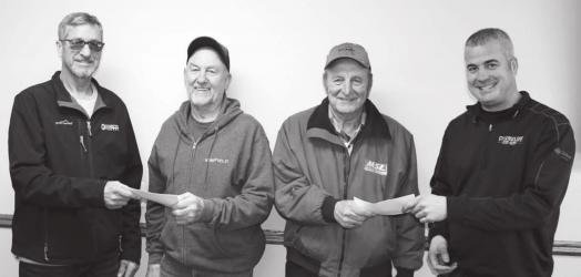Pictured is Curt Van Dyke, Board Chairman (left), presenting a retirement check to Harley Buys, and Jeff Einck, Manager (right) presenting a check to Verlin Rylaarsdam.