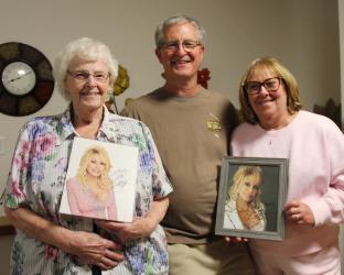Mary Lea Hemmen received a hand-delivered, hand-autographed photo of Dolly Parton for her 86th birthday. She is pictured with the photo and with her nephew-in-law and niece, Tod and Paula Harvey. The Harvey’s son is married to Dolly’s second cousin, Kam.