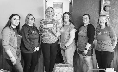 Judy LaBoda presenting a check to Wonder World board members. The funds represent donations from the Slayton Graduating Class of 1970.