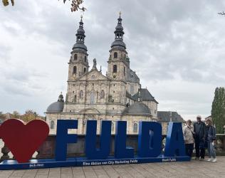 Duane and Shari Gehl, Tracey Robb at Fulda, Germany sign and cathedral.