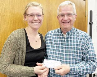 Maike Houser of Houser Homes, presents a check to Myron Koets, president of the Friends of the Casey Jones Trail.
